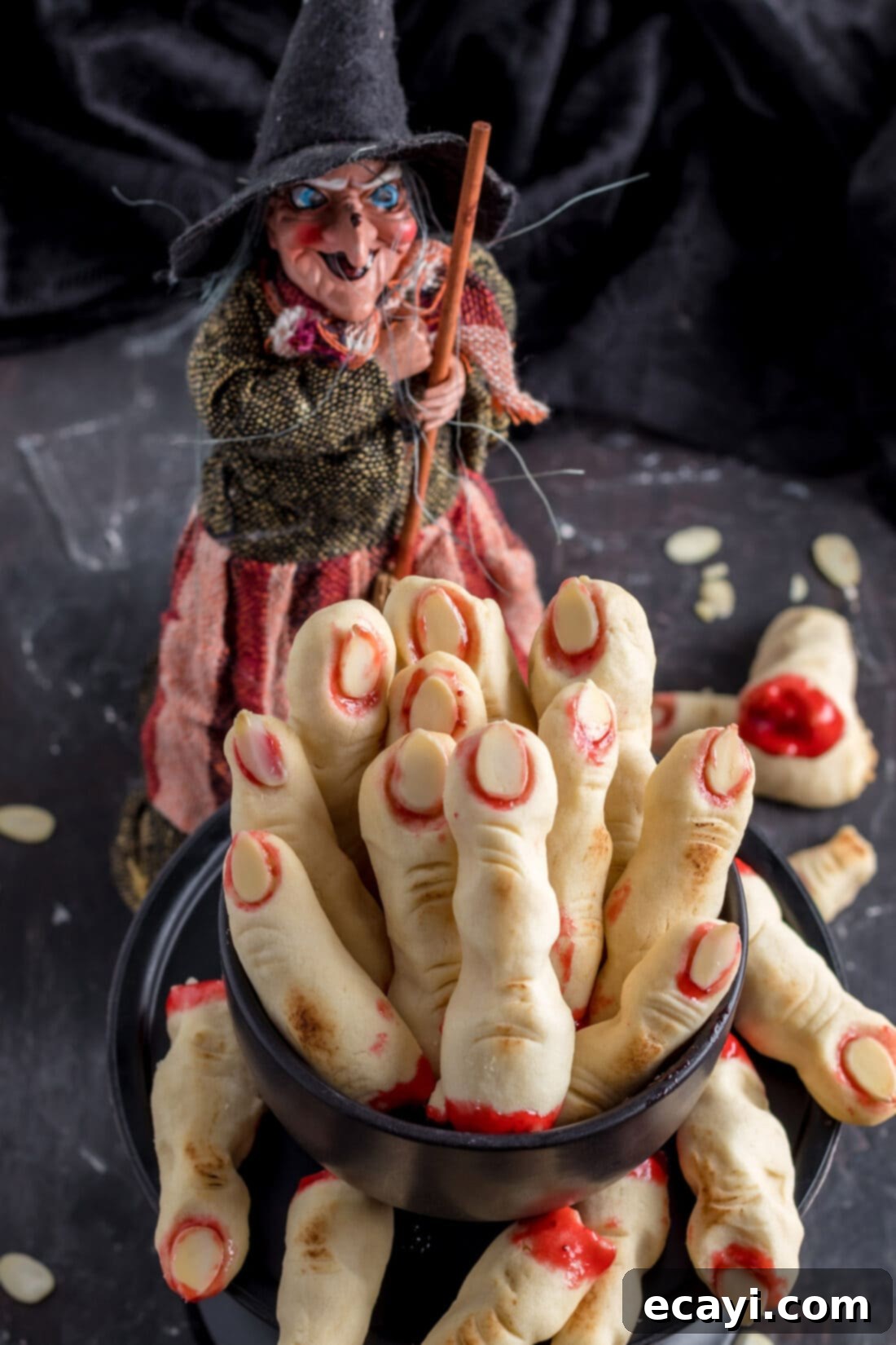 Wicked Fingers 17 A dish filled with an abundance of decorated Witch Finger Cookies, showcasing their spooky charm and deliciousness