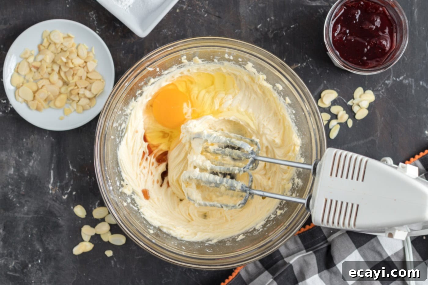 Wicked Fingers 6 Egg, vanilla, powdered sugar, and butter expertly mixed in a bowl, ready for dry ingredients