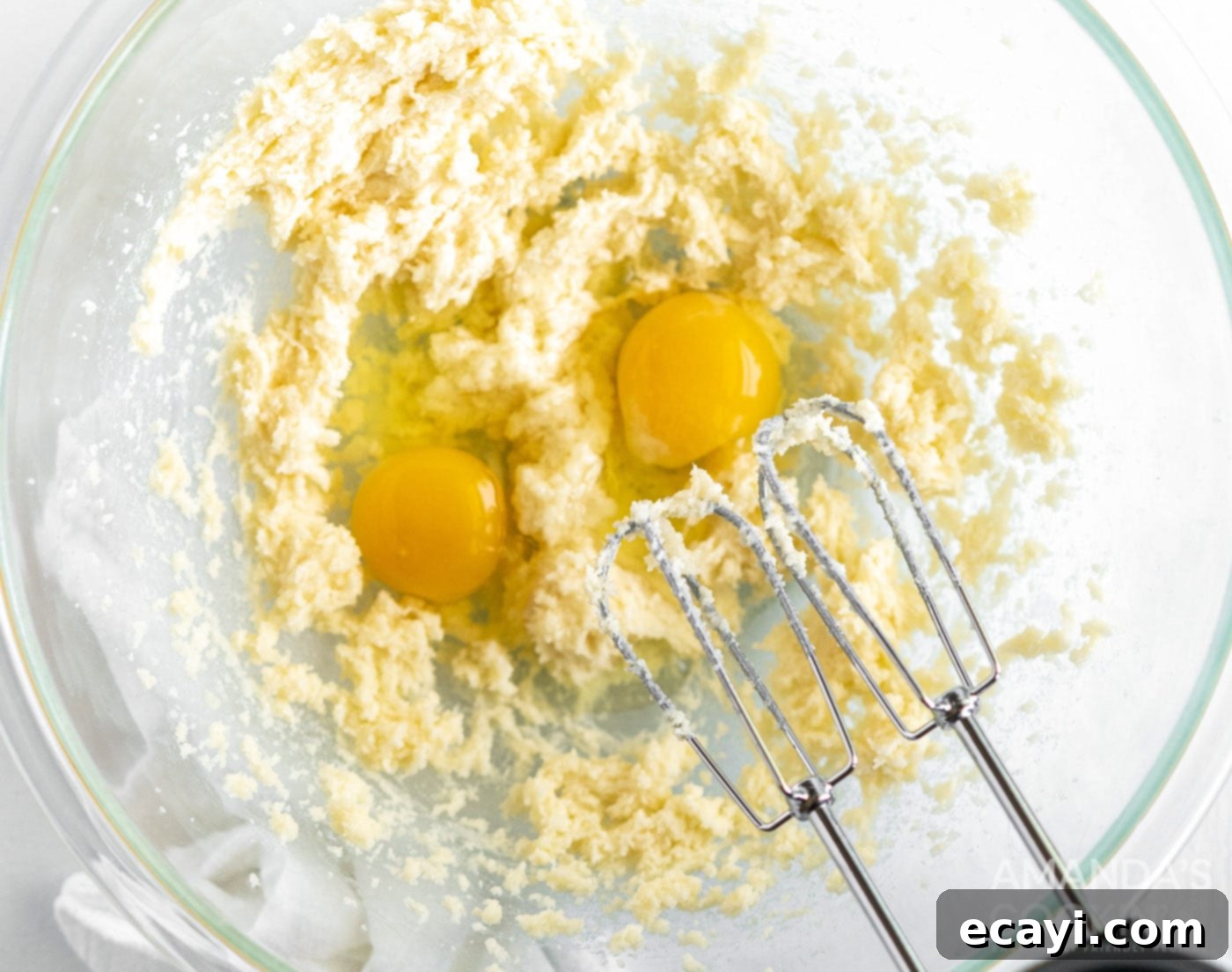 Golden Pound Cupcakes 6 hand mixer beating eggs into batter