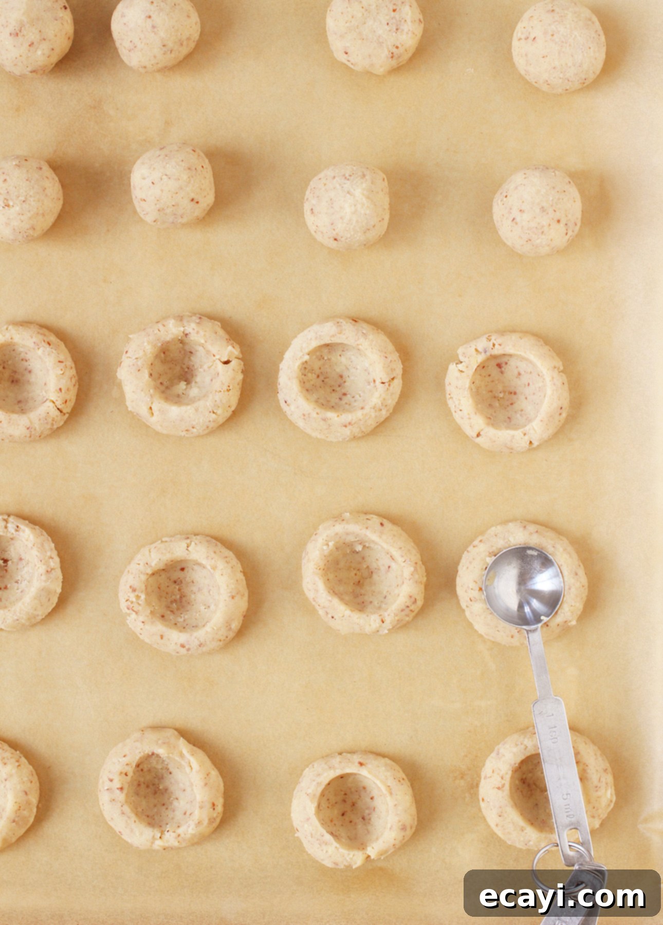 Golden Maple Pecan Indulgences 6 Creating indentations in maple thumbprint cookies // FoodNouveau.com