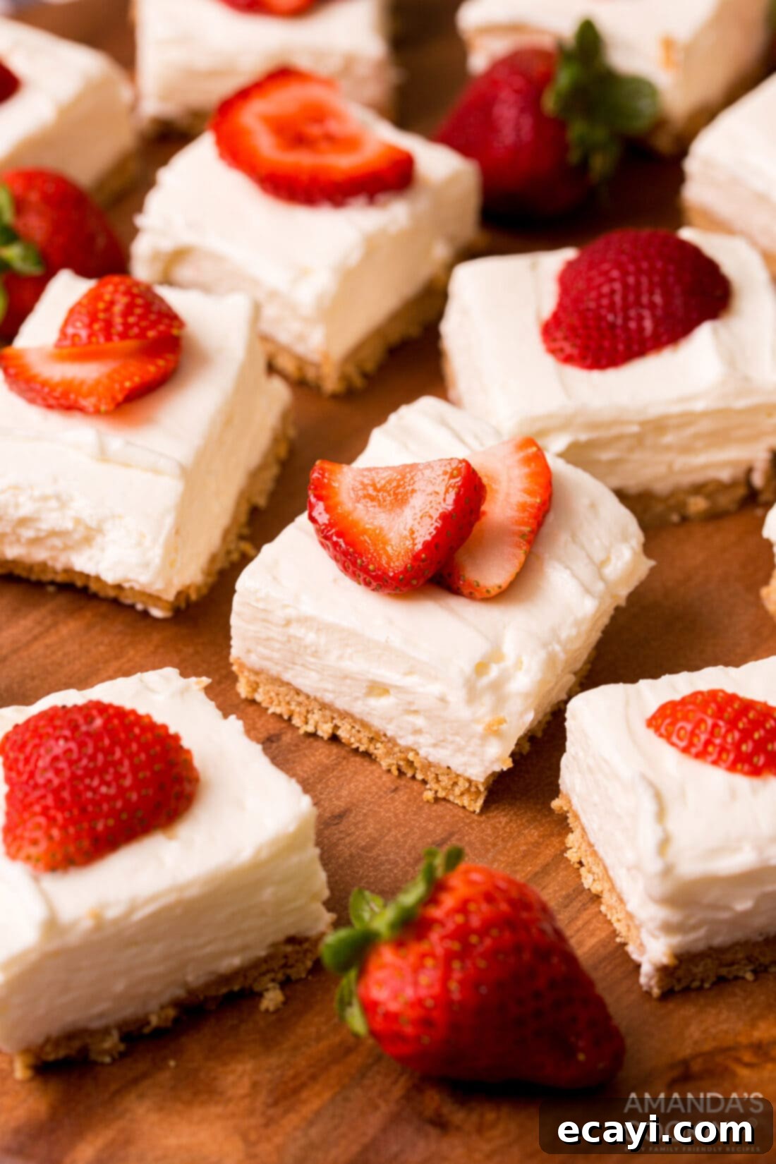Chilled Cheesecake Squares 2 No Bake Cheesecake Bars with strawberry garnish