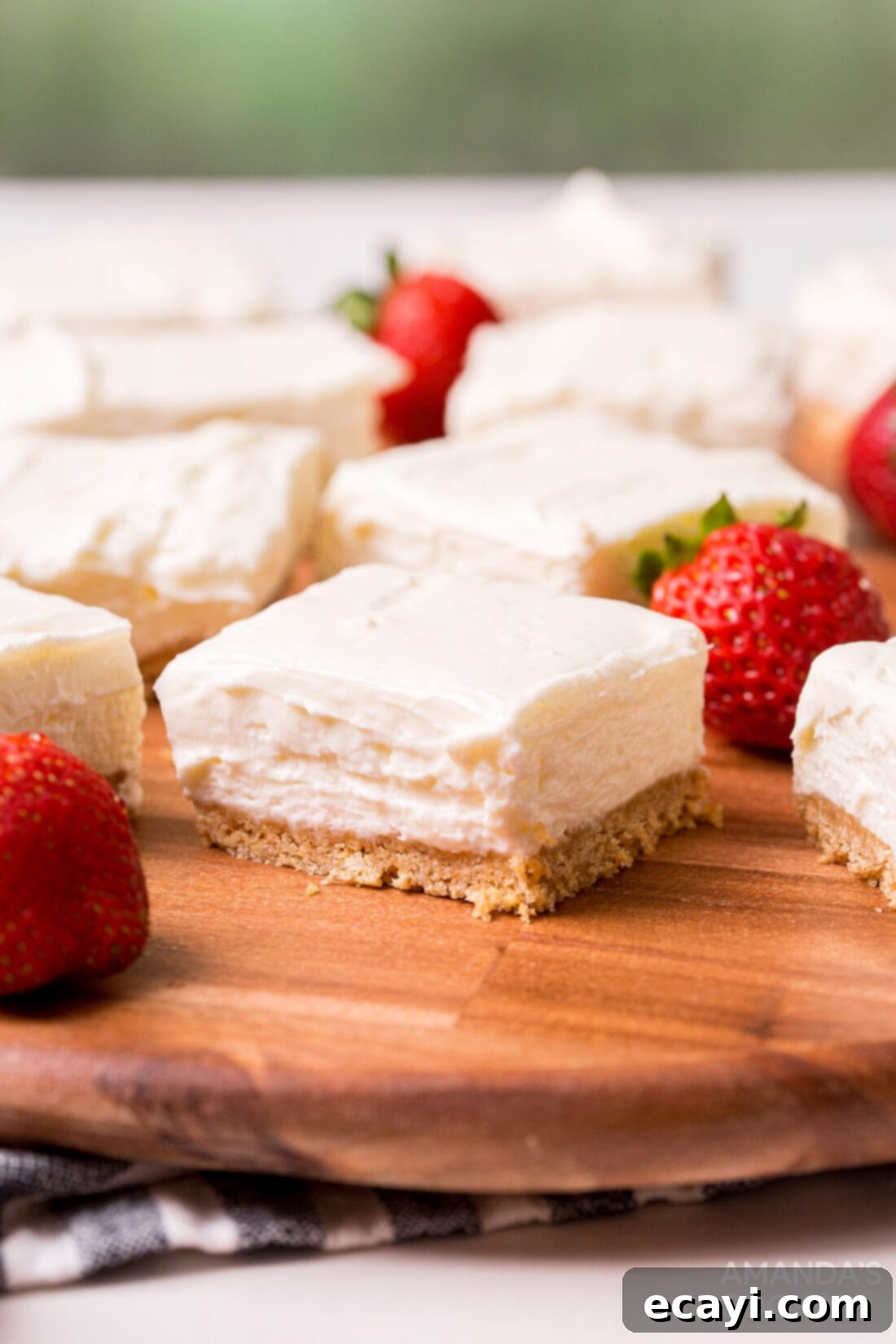 Chilled Cheesecake Squares 3 No Bake Cheesecake Bars on a cutting board