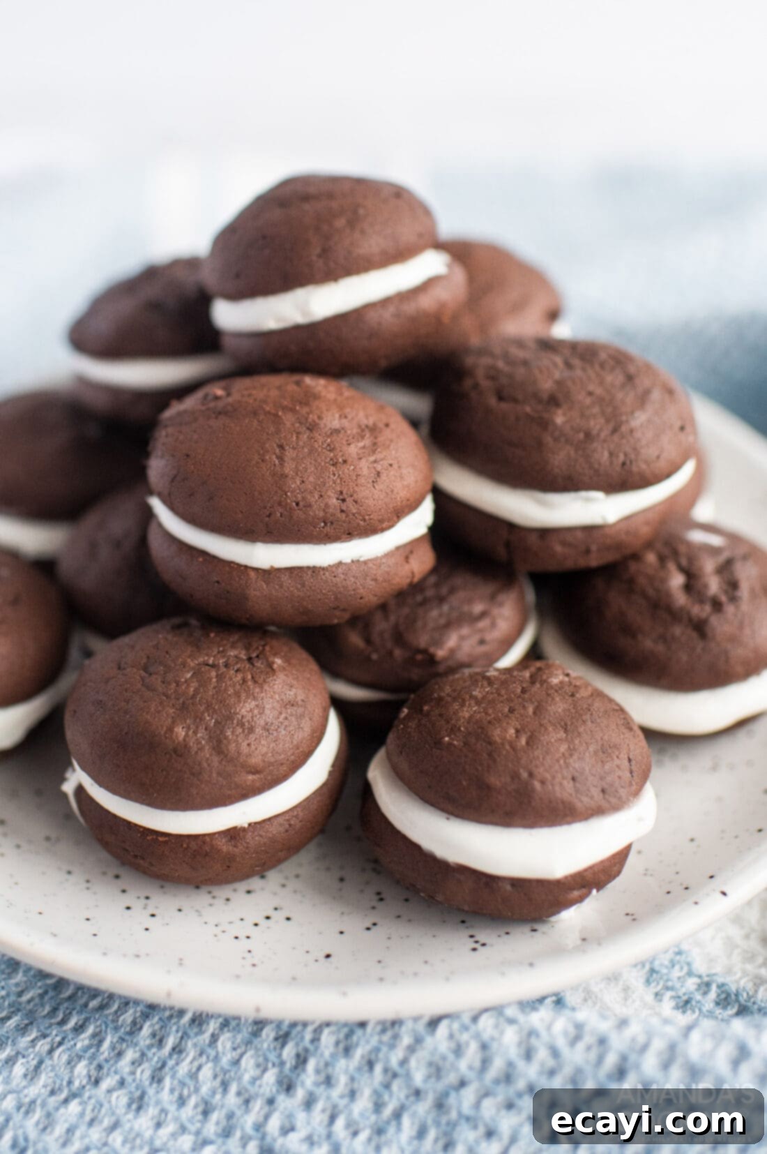 Velvety Chocolate Whoopie Indulgence 2 Plate piled high with irresistible homemade Chocolate Whoopie Pies, featuring rich chocolate cakes and a creamy white marshmallow filling.