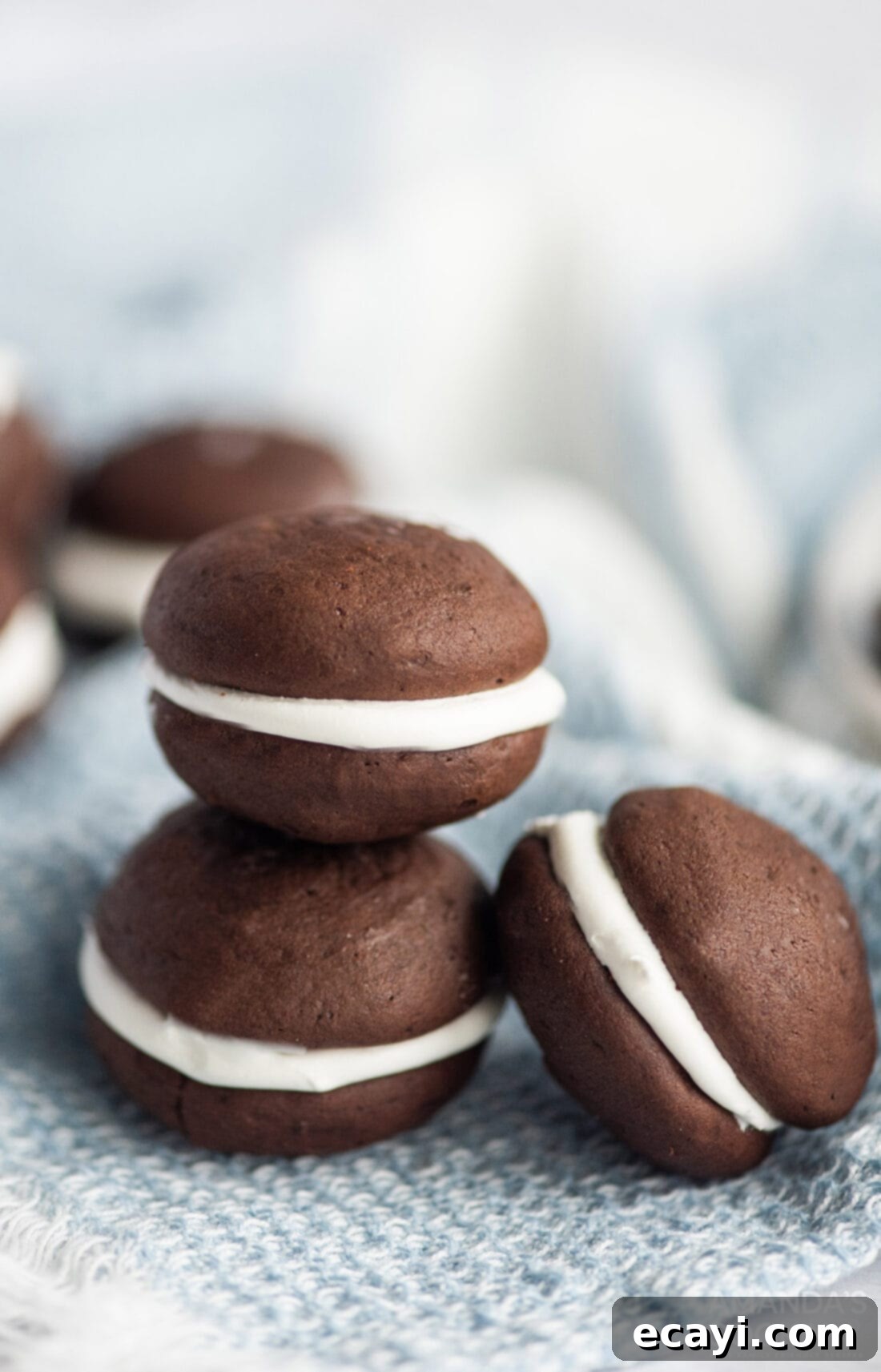Velvety Chocolate Whoopie Indulgence 3 Three perfectly assembled Chocolate Whoopie Pies displayed, showing the thick chocolate cakes and generous marshmallow cream filling.