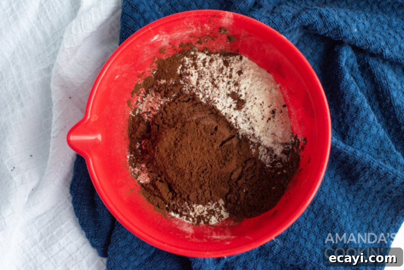 Velvety Chocolate Whoopie Indulgence 6 Mixing dry ingredients: cocoa powder, flour, baking soda, and salt in a bowl.