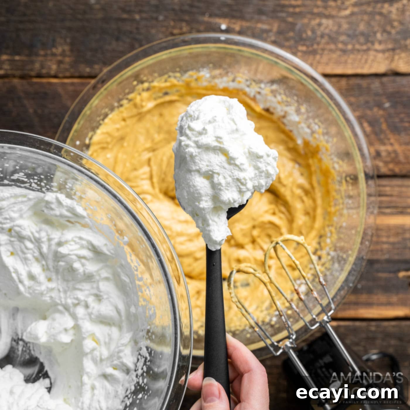 Spiced Pumpkin Pie Dip 7 spoonful of whipped cream being added over cream cheese pumpkin mixture