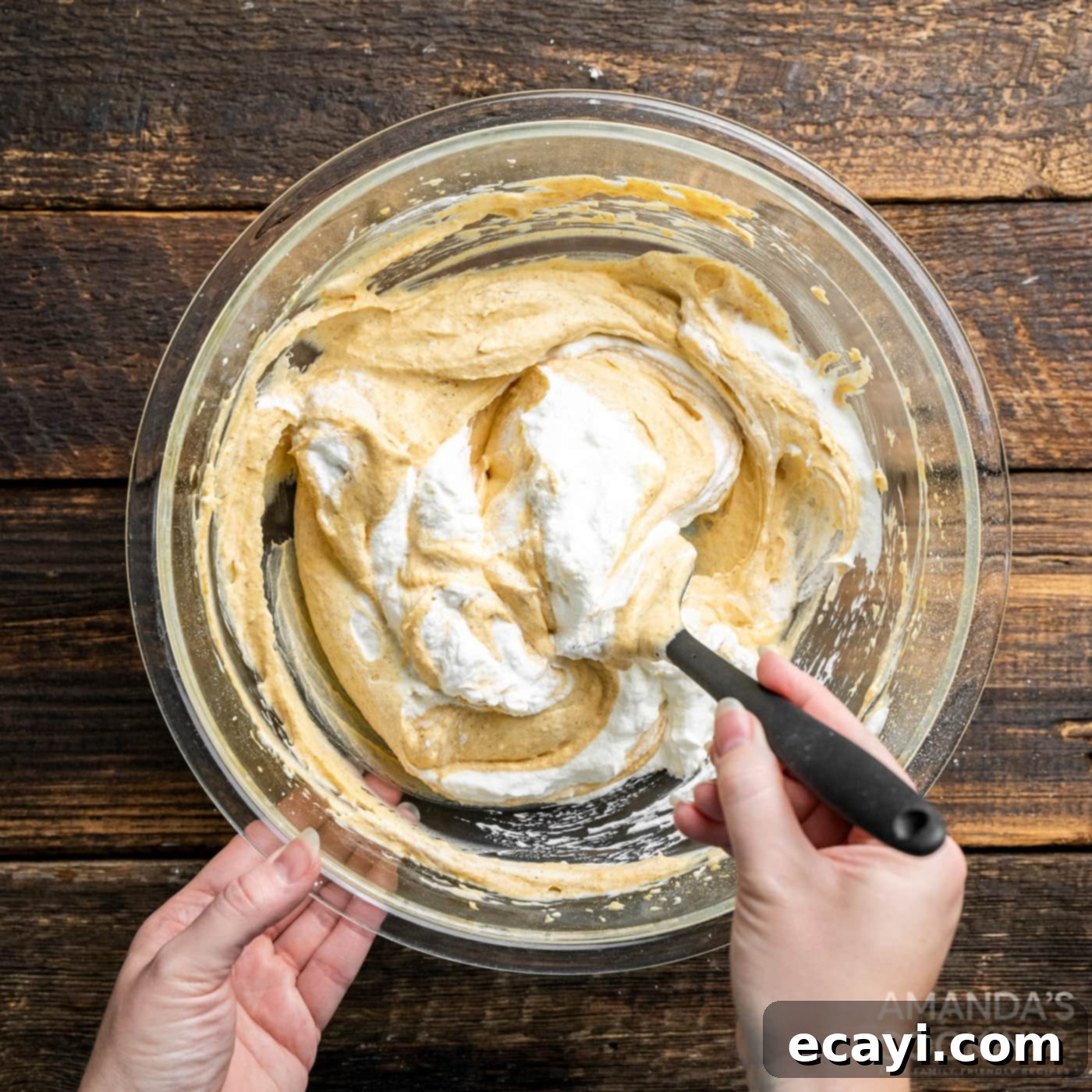 Spiced Pumpkin Pie Dip 9 whipped cream being folded into pumpkin cream cheese mixture with a spatula