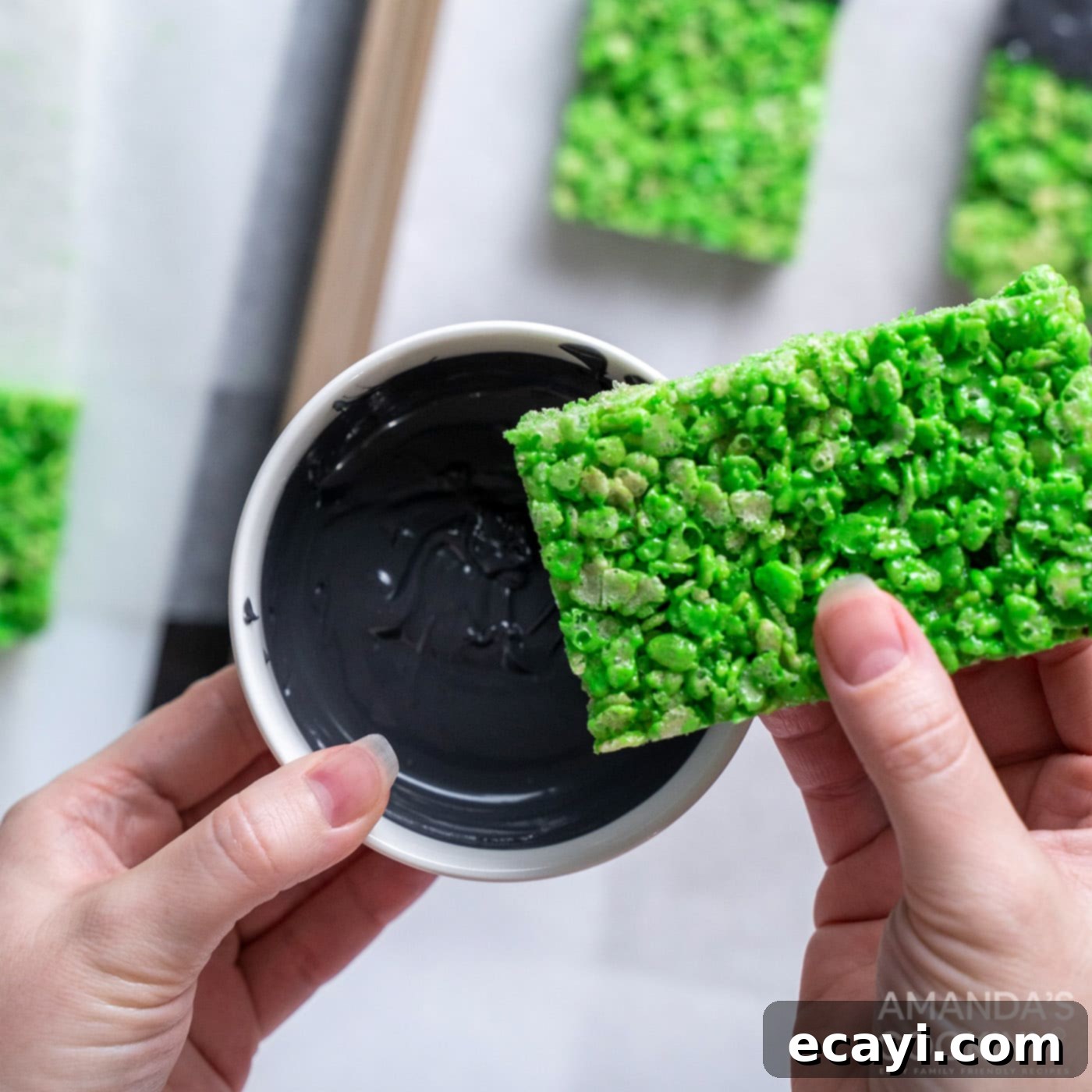Franken-Crispy Treats 13 hand dipping green rice krispie treat into candy melts