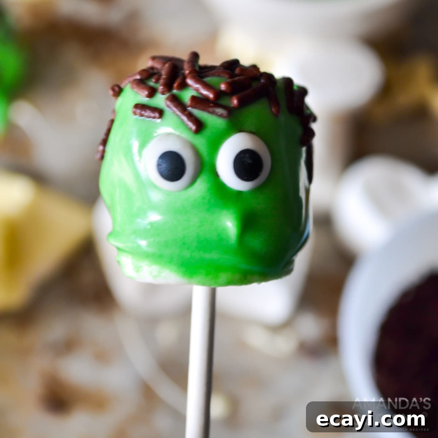 Franken-Mallow Creations 6 Marshmallow Frankenstein pops being decorated with candy eyes