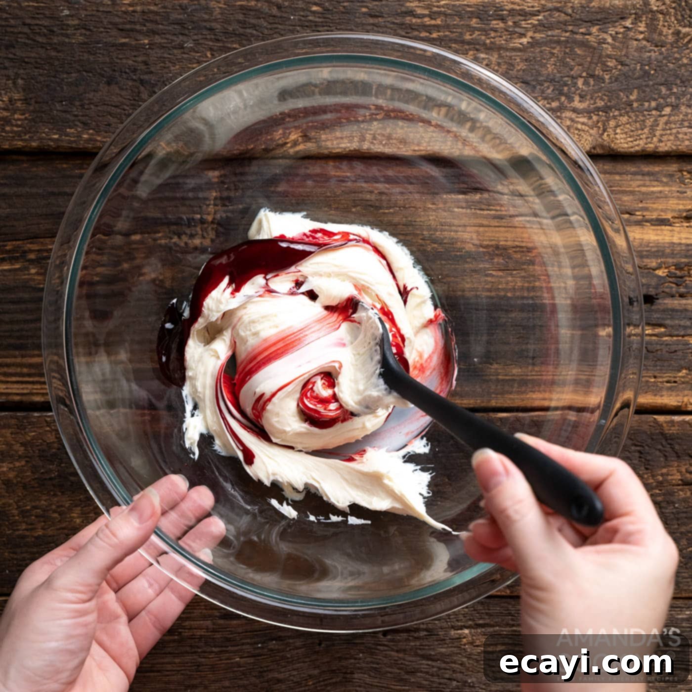 Vampire's Kiss Sandwich Cookies 6 Mixing red gel food coloring into vanilla frosting in a bowl