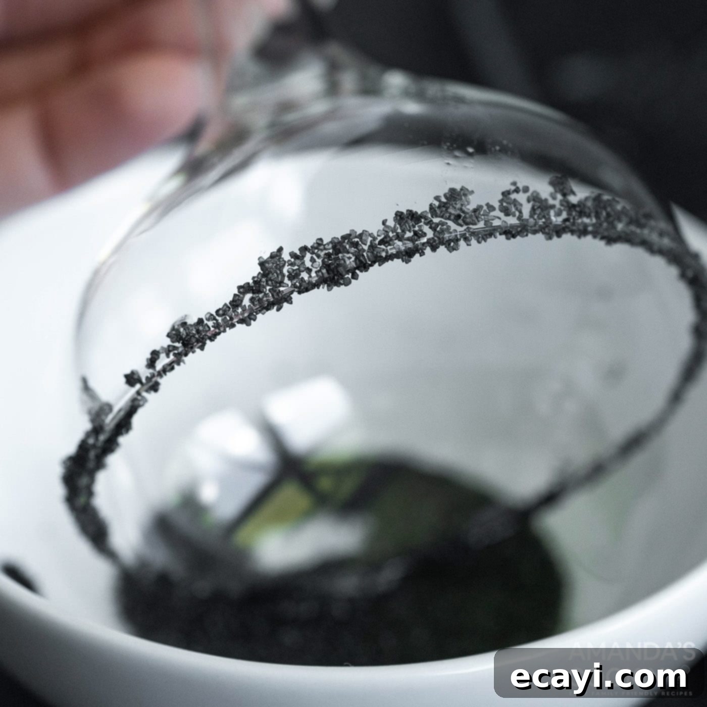 The Reanimated Margarita 6 dipping margarita glass in black salt for a Halloween themed rim