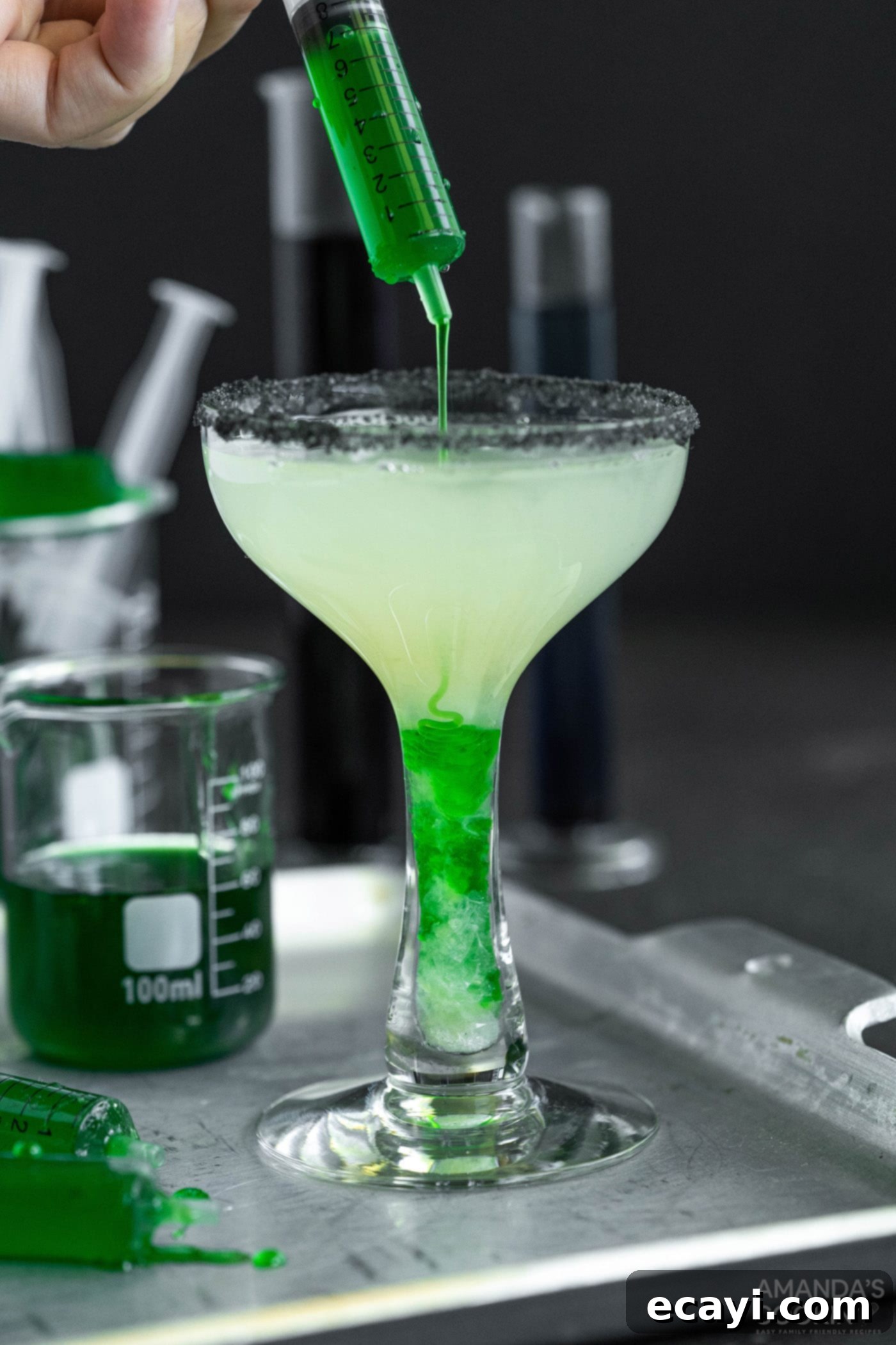 The Reanimated Margarita 7 adding green goo to a Frankenstein margarita for a vibrant color