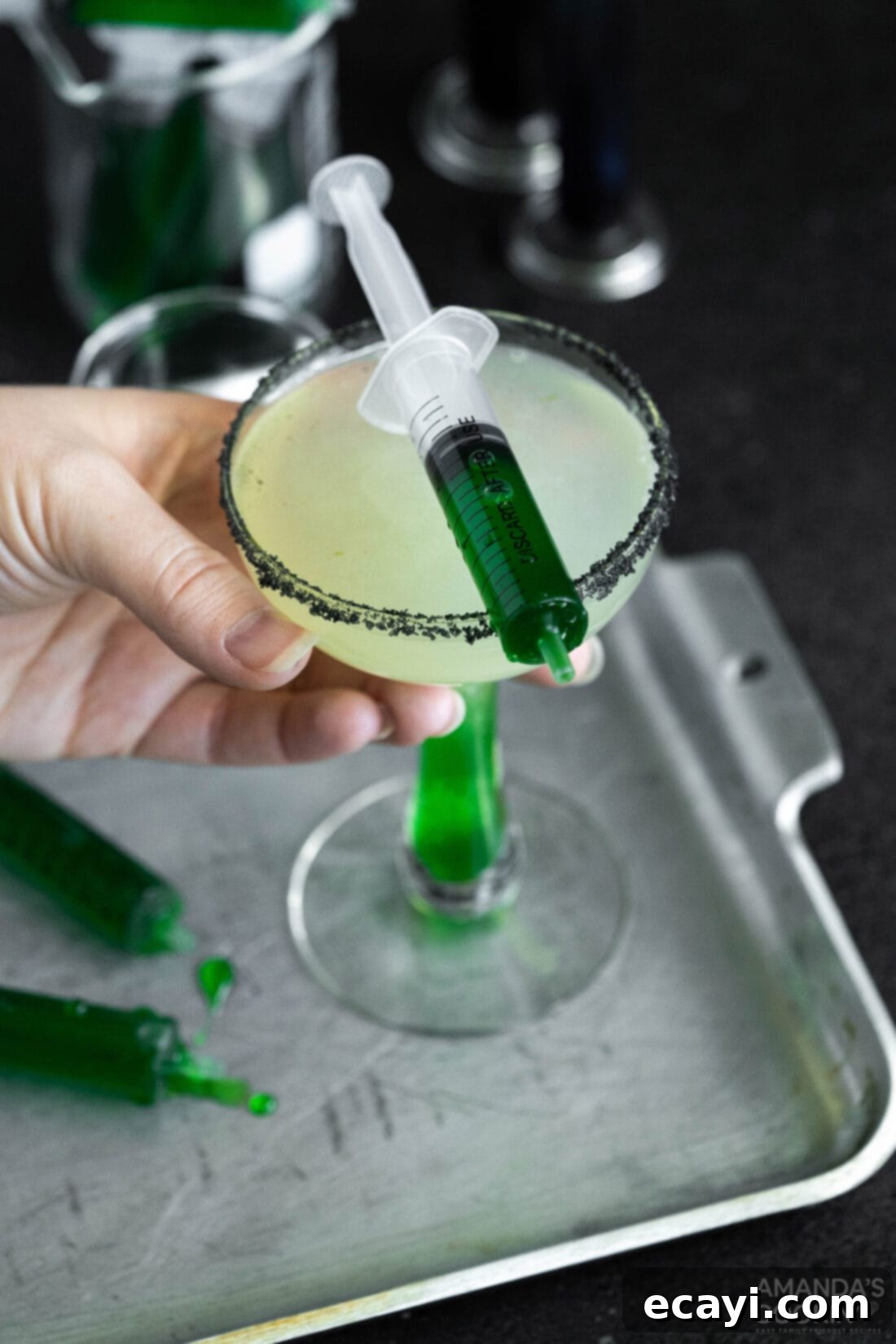 The Reanimated Margarita 8 lifting a Frankenstein Margarita glass against a spooky backdrop