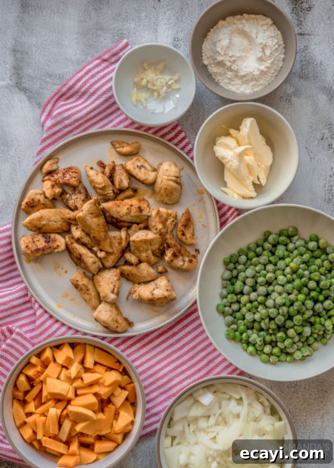 Golden Harvest Chicken Pot Pie 4 All ingredients laid out for preparing Pumpkin Chicken Pot Pie, including fresh pumpkin, chicken, and puff pastry