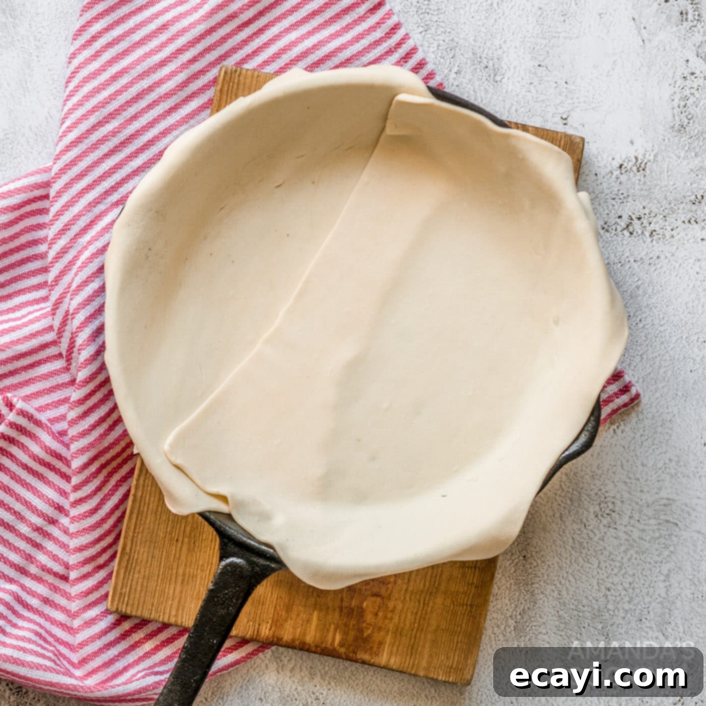 Golden Harvest Chicken Pot Pie 7 Puff pastry carefully lined in a 12-inch skillet, ready for filling