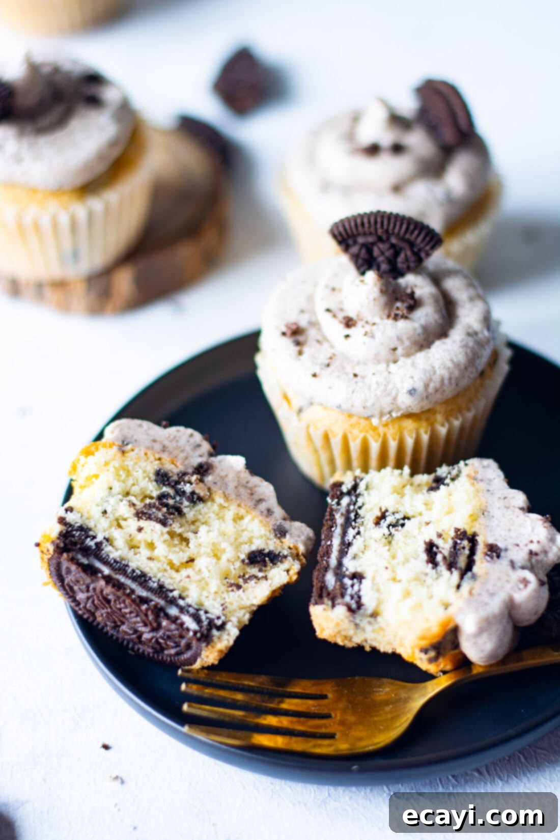 Ultimate Oreo Cupcakes 13 Two Oreo Cupcakes cut in half, showcasing the cookie base and creamy frosting