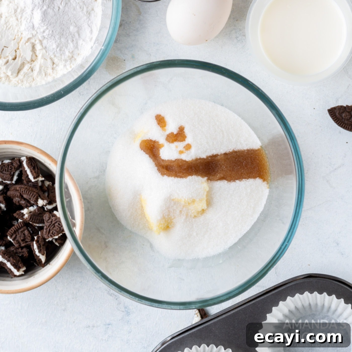 Ultimate Oreo Cupcakes 5 softened butter, granulated sugar, and vanilla extract being mixed in a bowl