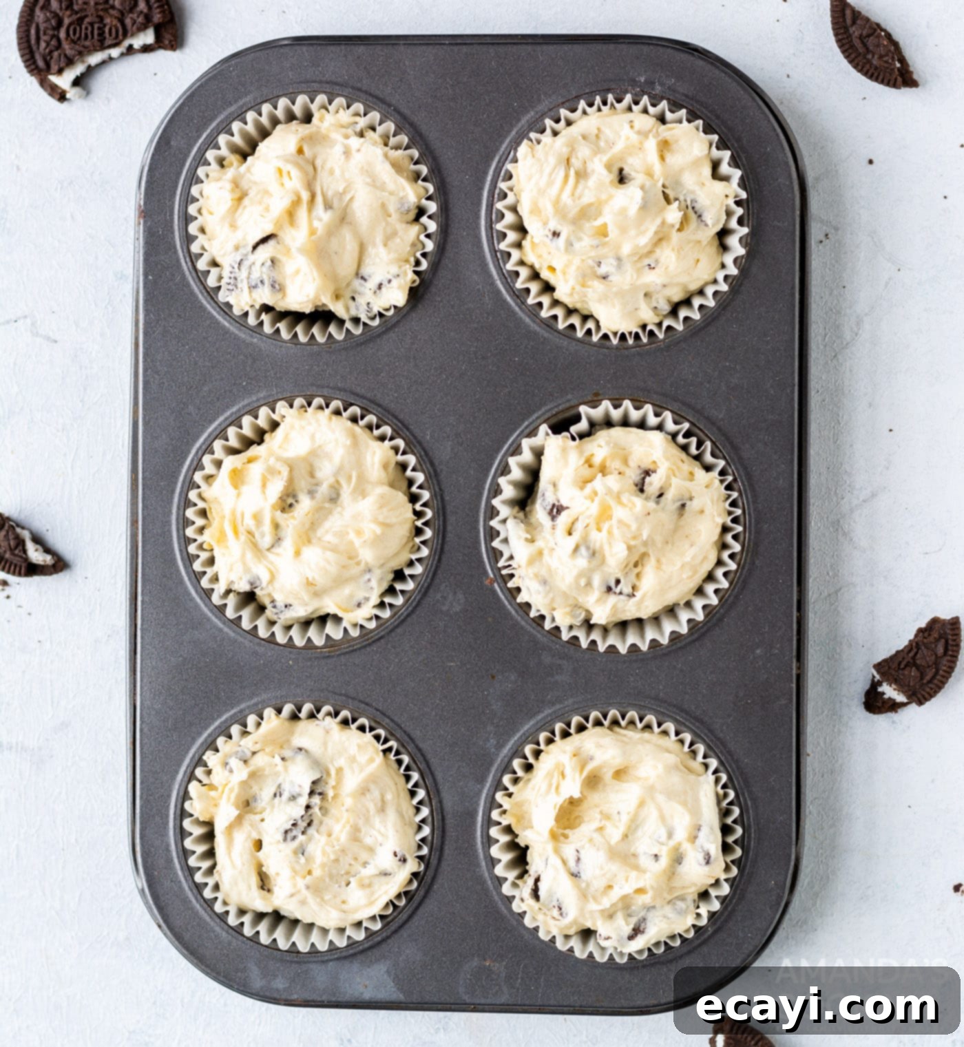 Ultimate Oreo Cupcakes 10 oreo cupcake batter filling cupcake liners in a tin