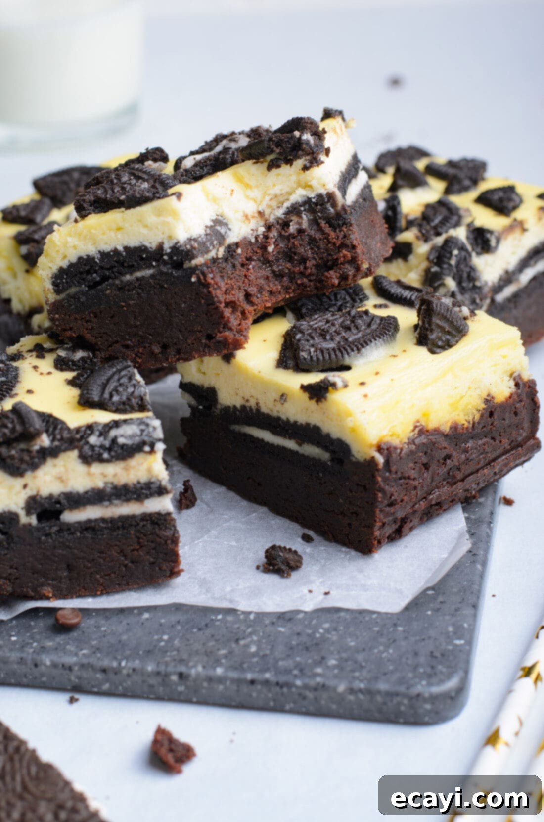 Decadent Oreo Cheesecake Brownies 13 A close-up of an Oreo Cheesecake Brownie bar with a bite taken out, revealing the soft brownie, crisp Oreo, and creamy cheesecake layers.