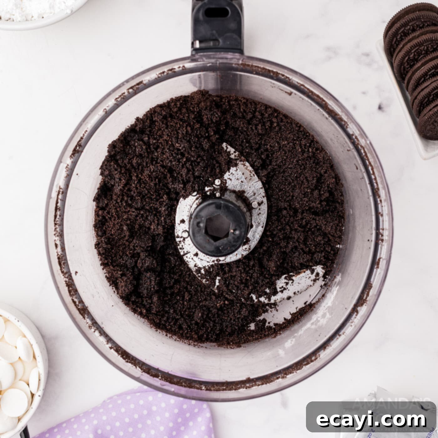 Decadent Oreo Cheesecake 5 Oreo cookies crushed into fine crumbs in a food processor, mixed with melted butter for the cheesecake crust.