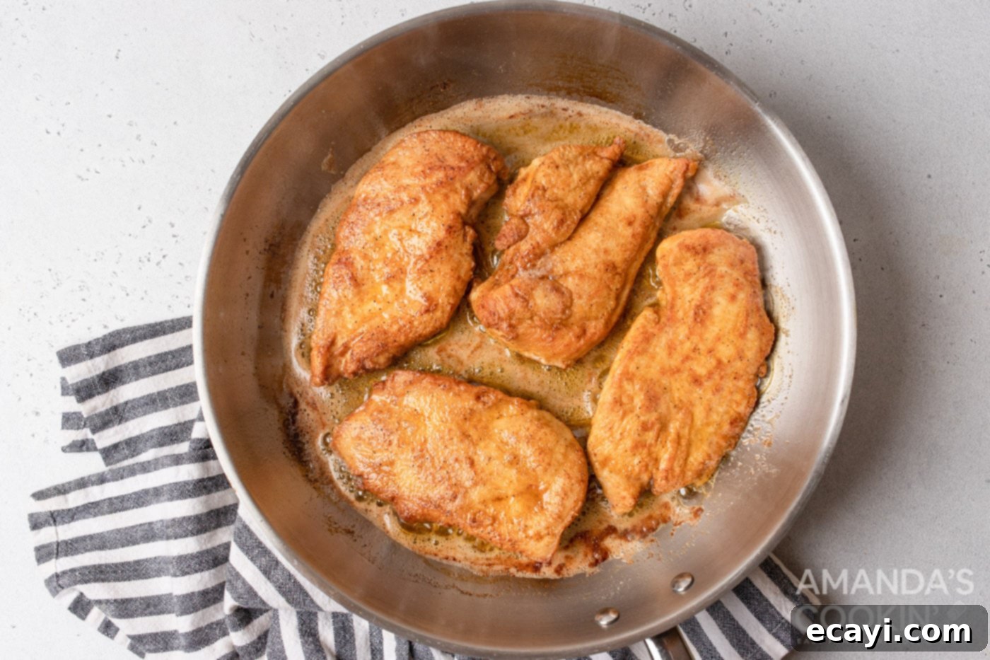 Creamy Chicken Stroganoff 6 chicken cooking on a pan with butter and oil