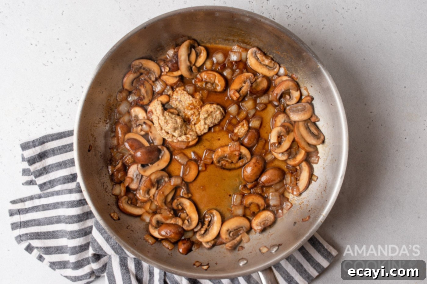 Creamy Chicken Stroganoff 8 white wine with mushrooms and onions sauteed on a skillet