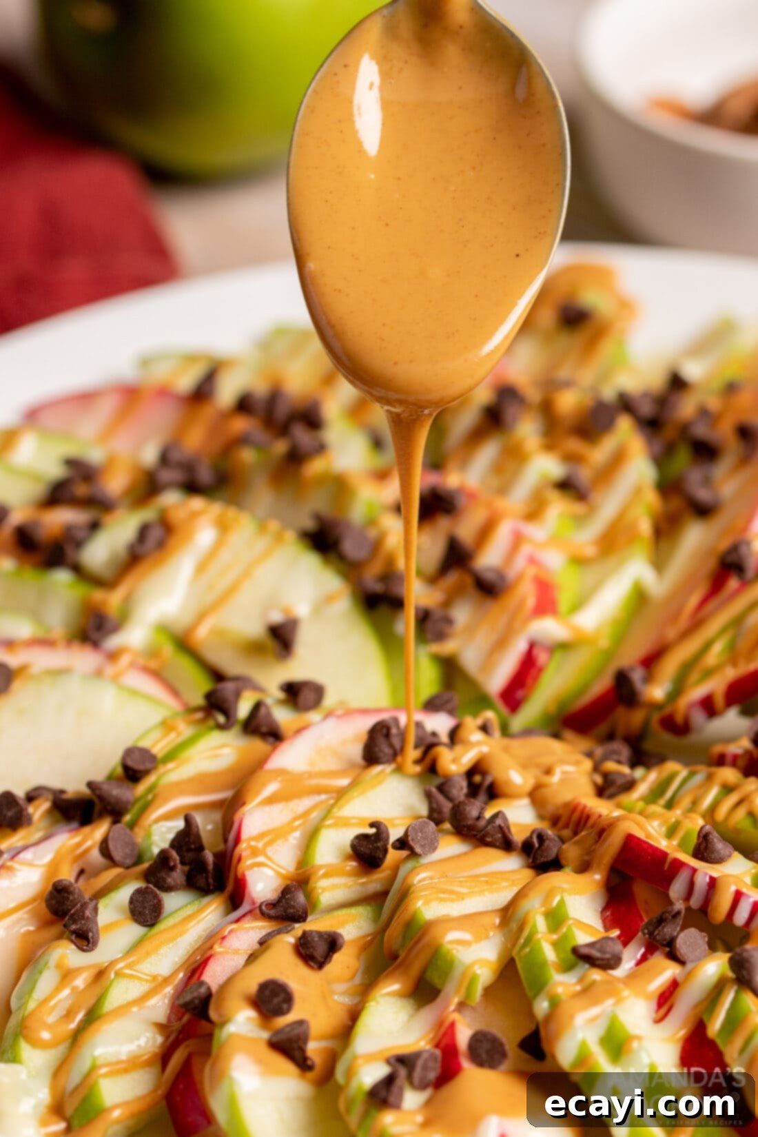 Orchard Nachos 3 drizzle peanut butter on Apple Nachos for a delicious snack