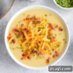 Creamy Cheddar Potato Soup 7 bowl of potato cheese soup garnished with bacon