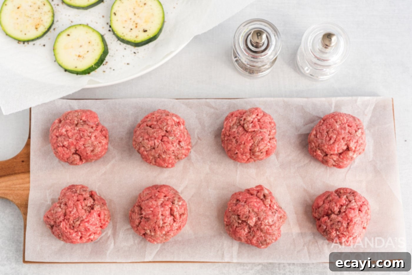 Mini Zucchini Bites 7 mini burger patties shaped and ready for cooking on parchment paper