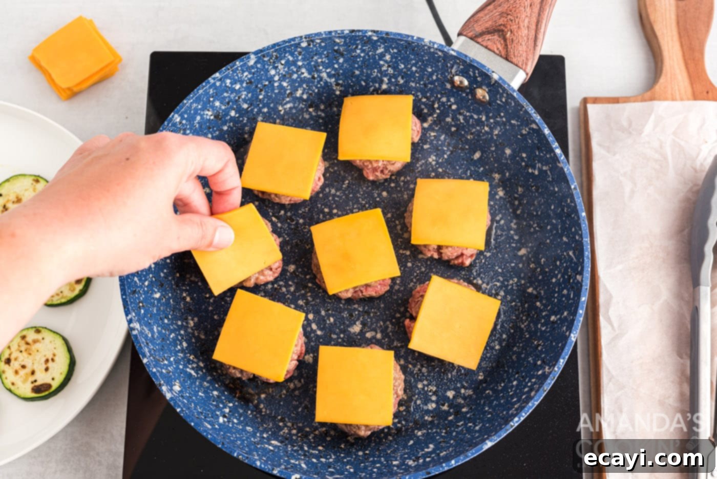 Mini Zucchini Bites 10 mini cheeseburgers in a skillet with perfectly melted cheese