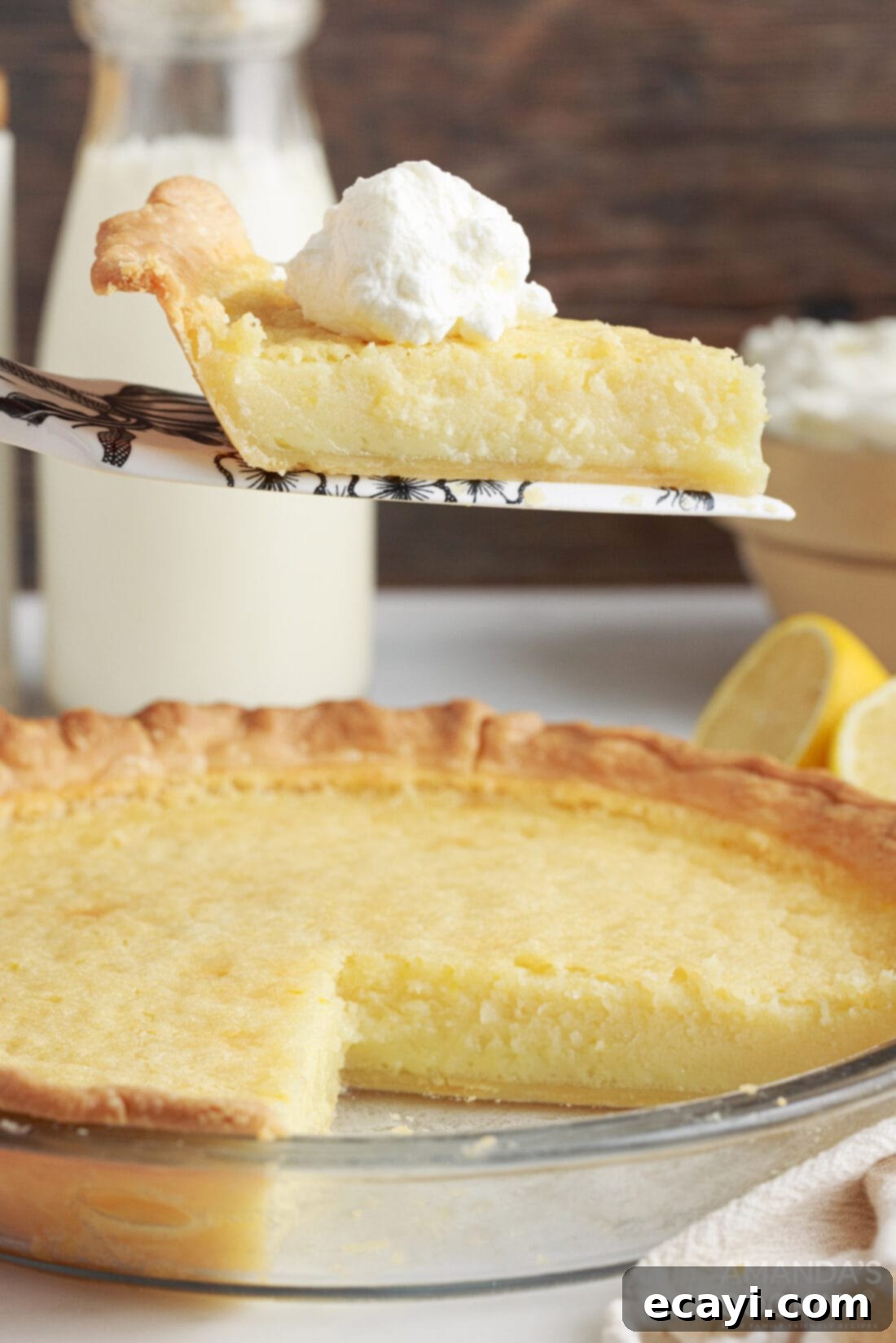 Down-Home Southern Buttermilk Pie 2 slice of Southern Buttermilk Pie being removed from pan