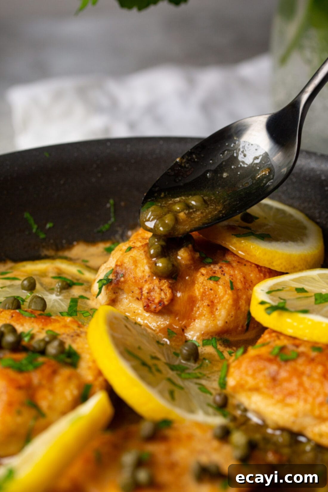 Lemon Caper Chicken 9 Close-up of fresh capers being drizzled over Chicken Piccata.