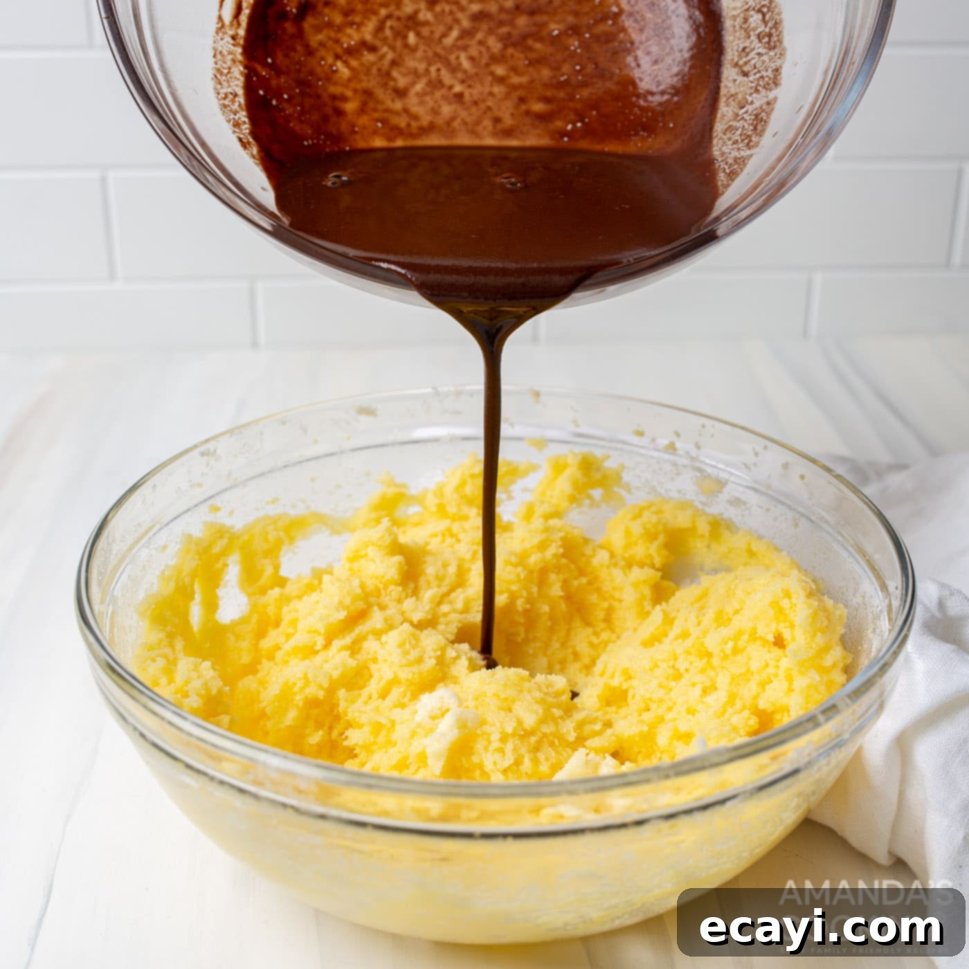 Decadent Coconut Pecan Chocolate Cake 6 Pouring cooled melted chocolate into the creamed butter, sugar, and egg yolk mixture