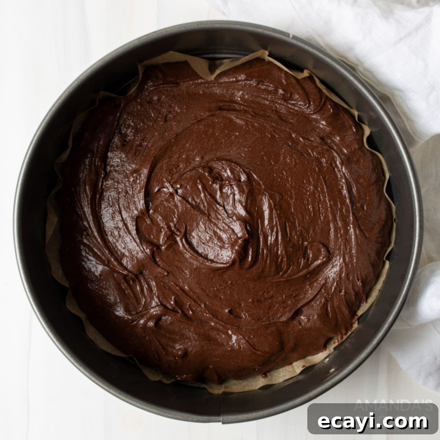 Decadent Coconut Pecan Chocolate Cake 8 Chocolate cake batter poured into a round baking pan