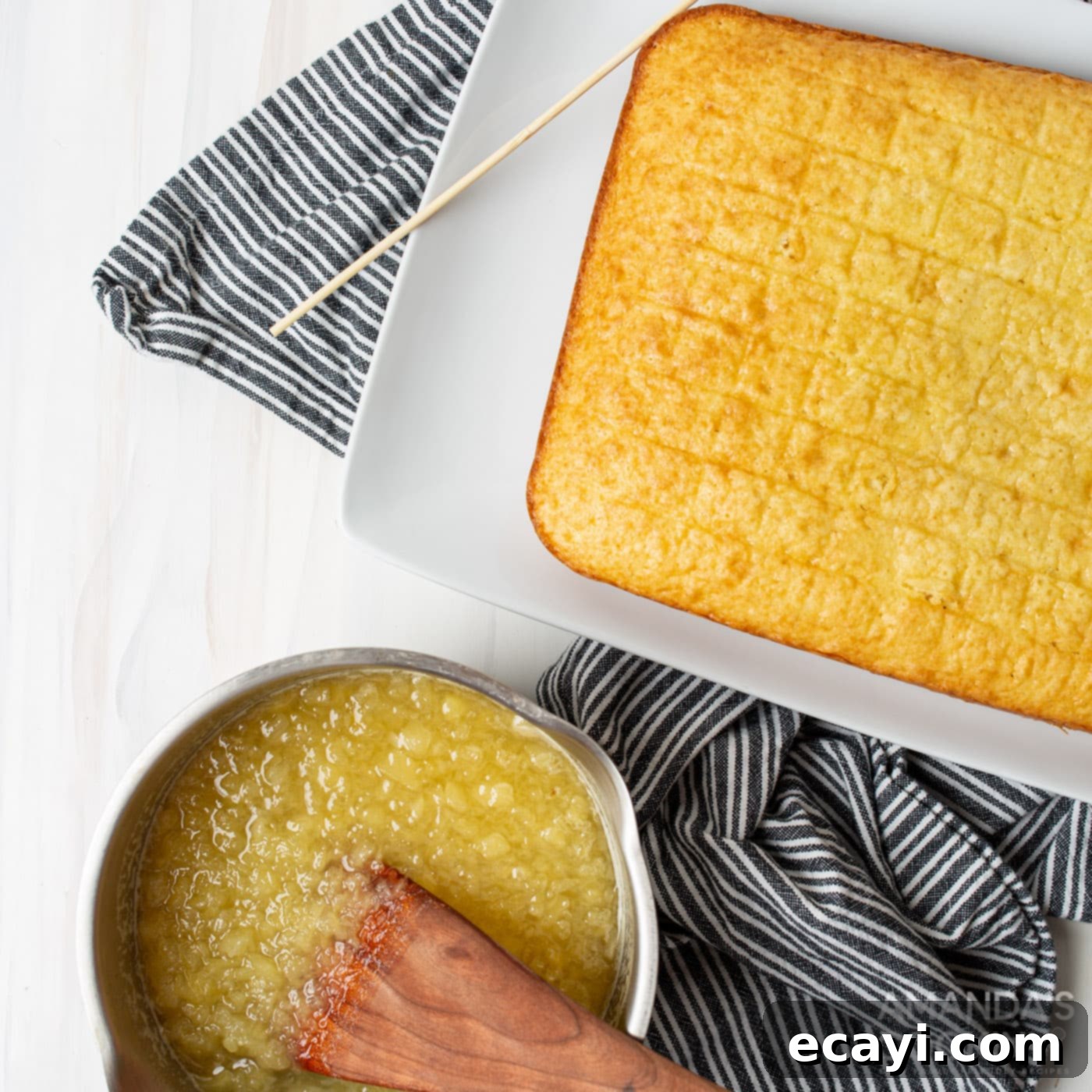 The King's Confection 8 hand in pineapple mixture next to cake