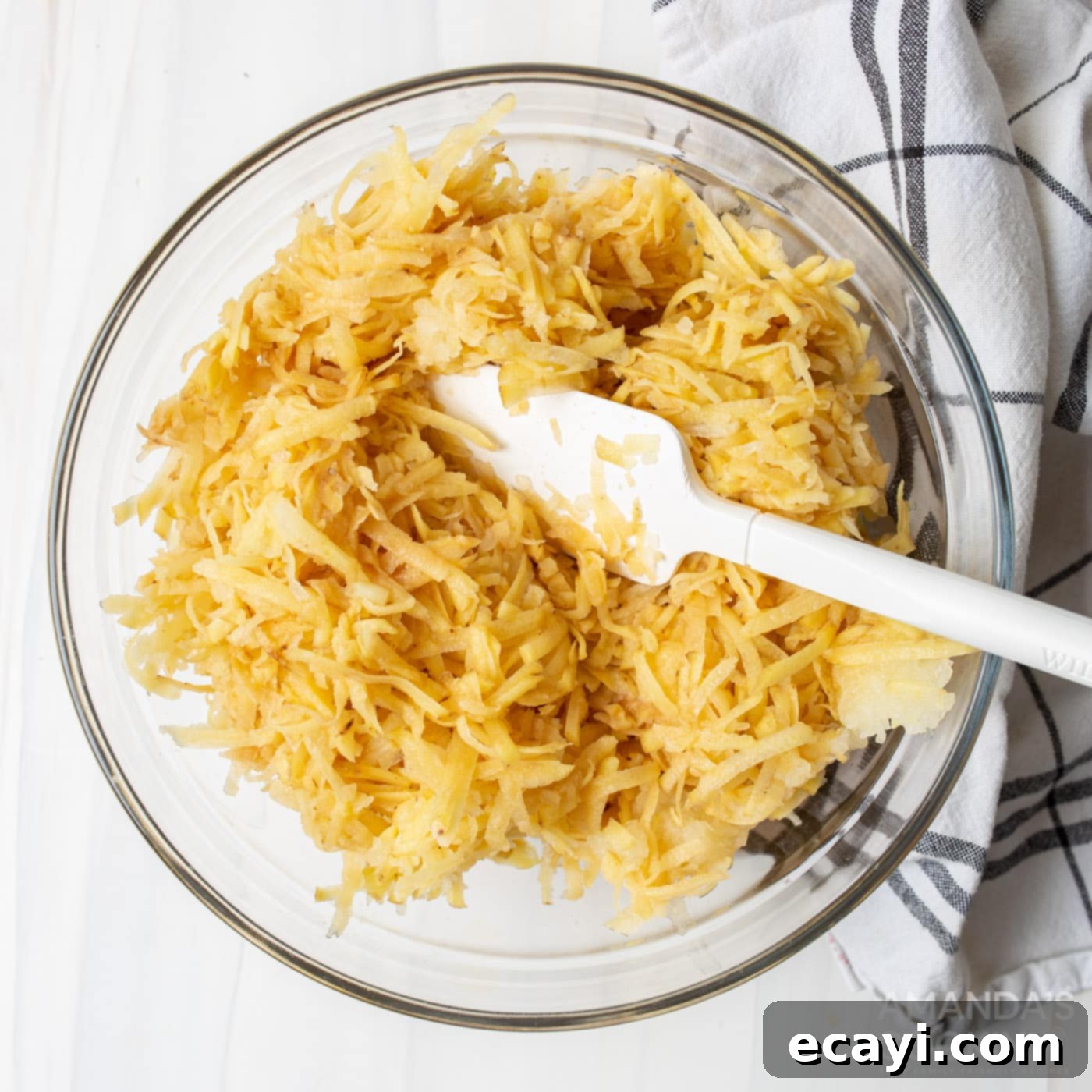 Sizzling Spud Cakes 5 grated potatoes in a bowl