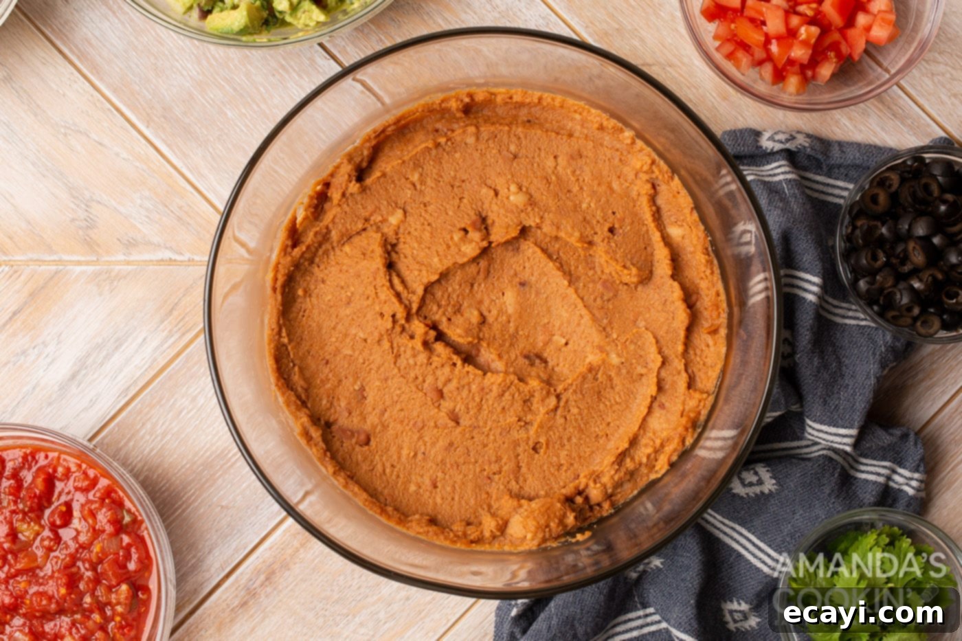 Ultimate Seven Layer Taco Dip 5 refried beans in a bowl