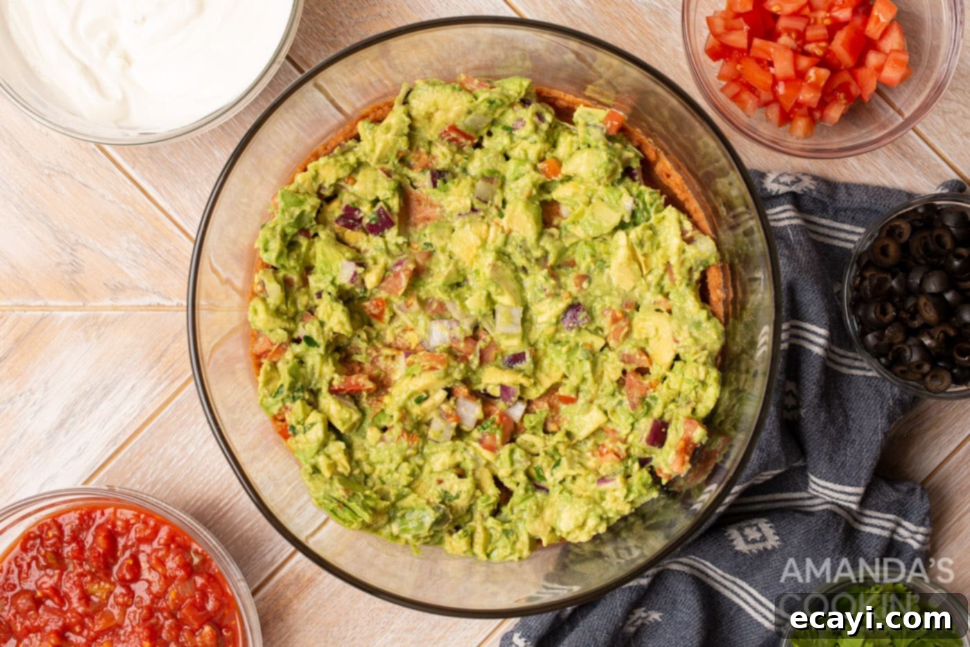 Ultimate Seven Layer Taco Dip 6 guacamole in a bowl