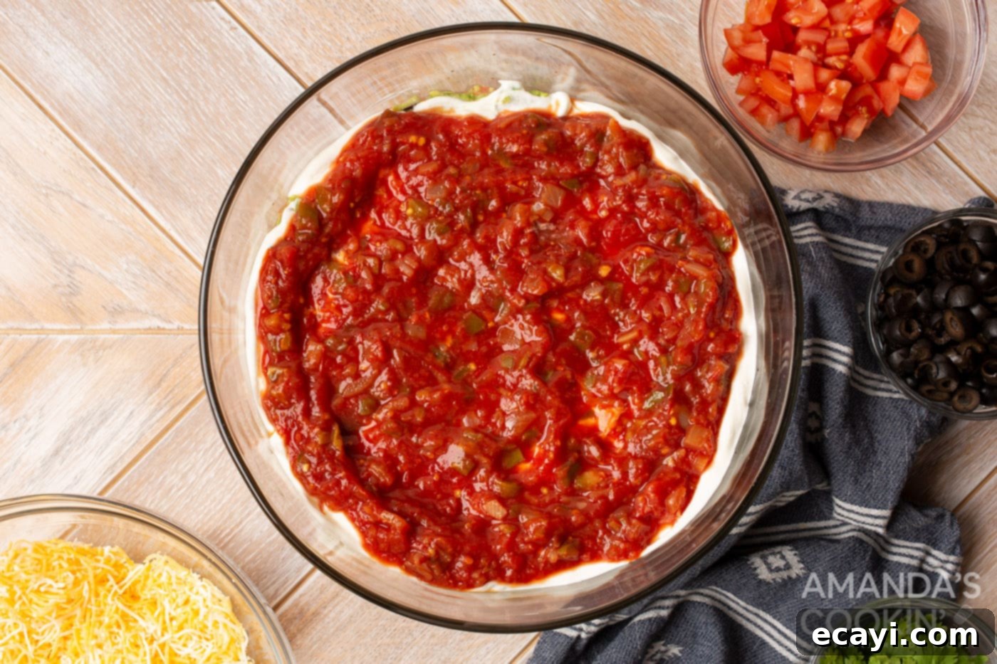 Ultimate Seven Layer Taco Dip 7 salsa on top of sour cream in a bowl