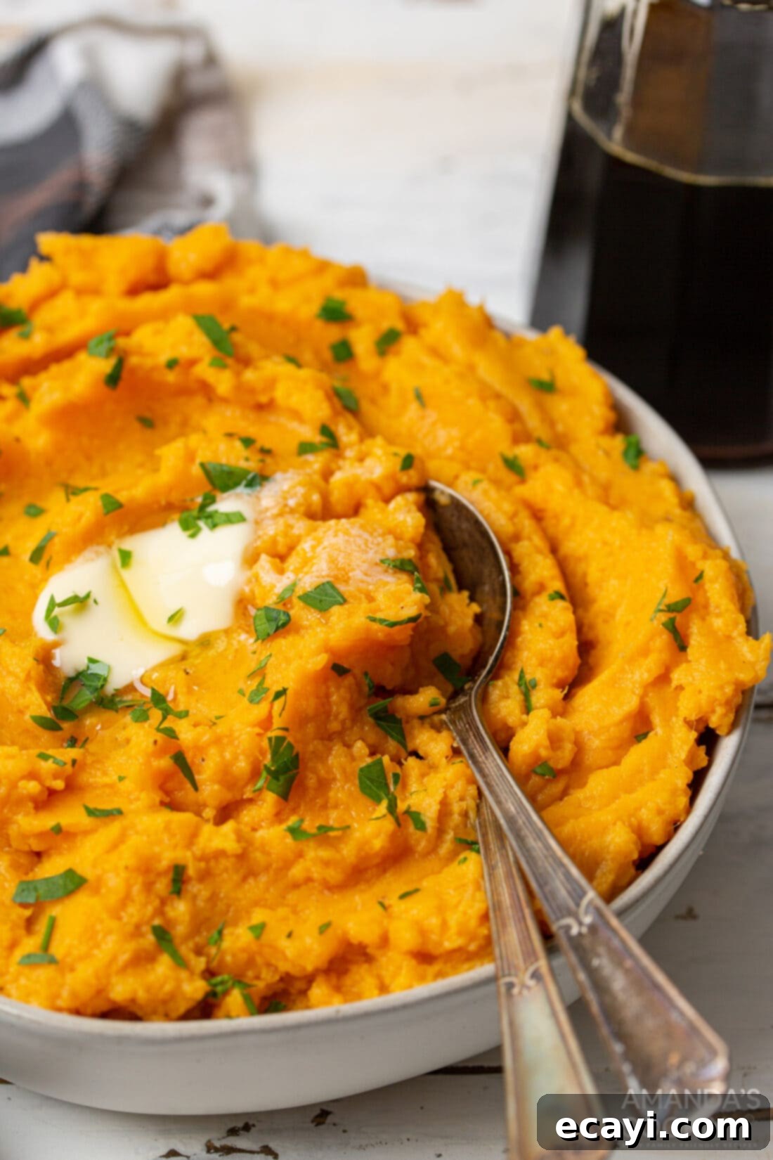 Creamy Sweet Potato Mash 2 bowl of Mashed Sweet Potatoes with spoon