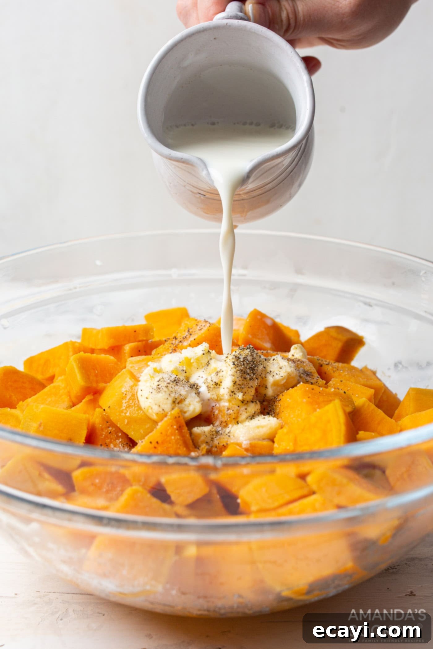 Creamy Sweet Potato Mash 6 pouring milk over butter and sweet potatoes