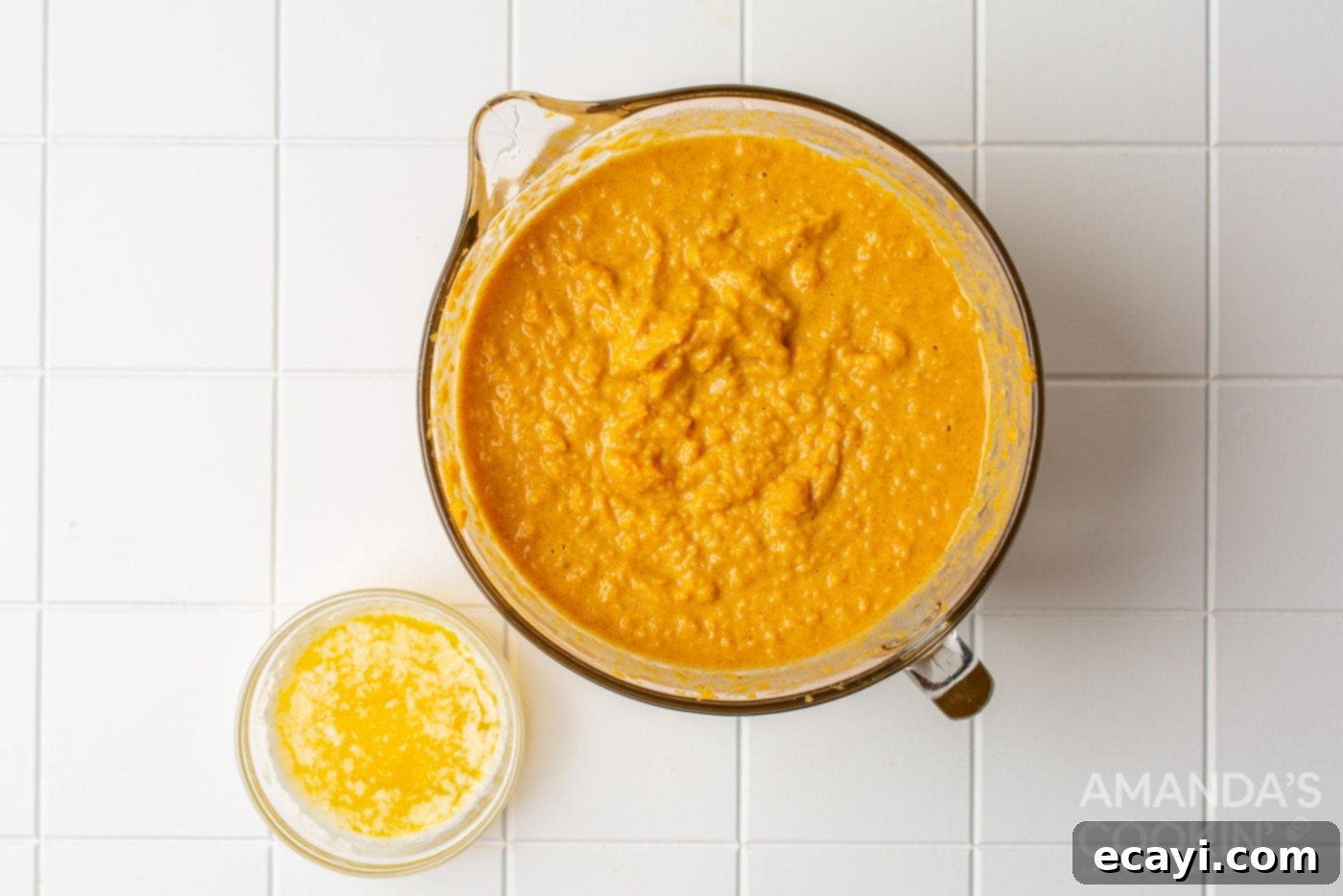 Classic Sweet Potato Pie 5 mashed sweet potatoes in a bowl with wet ingredients being poured in