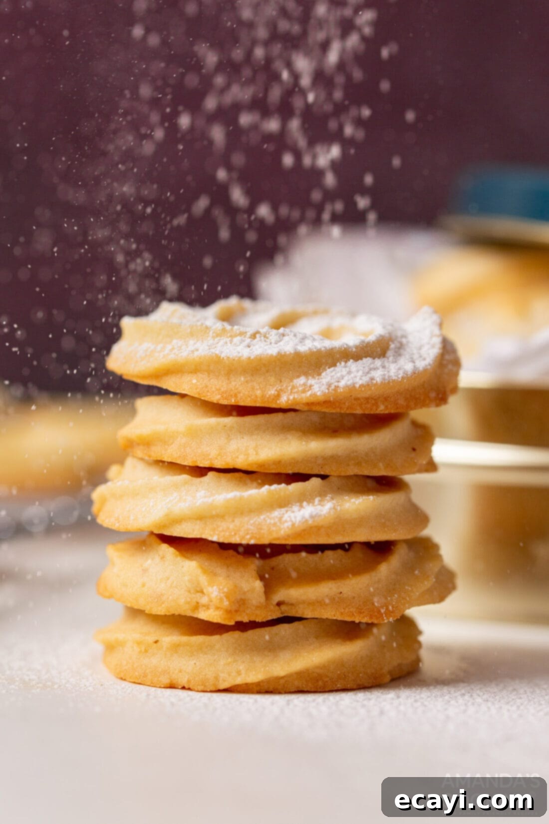 Buttery Danish Cookie Perfection 3 sprinkling powdered sugar on freshly baked Danish Butter Cookies