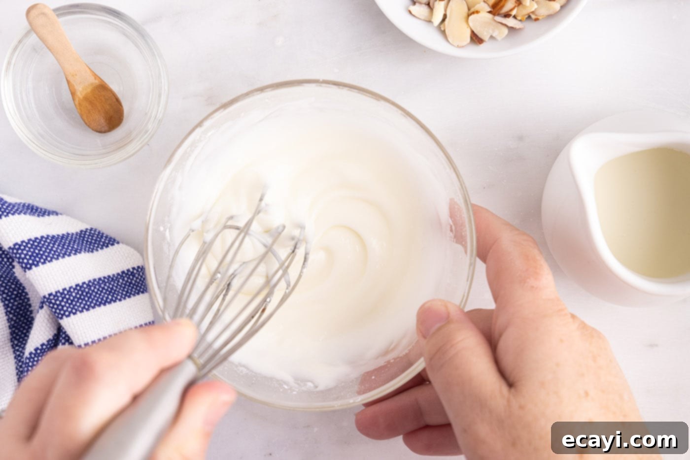 Artisan Danish Wreath 10 Whisking powdered sugar and almond extract with heavy cream to make the smooth icing for the danish.