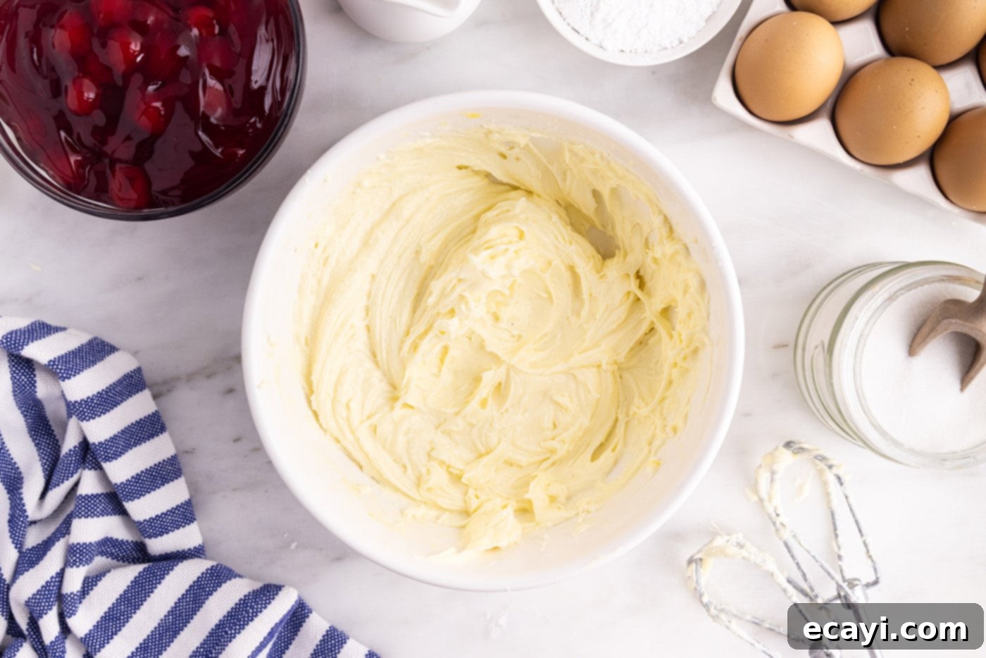 Artisan Danish Wreath 5 Cream cheese mixture being beaten until smooth and fluffy in a mixing bowl for the danish filling.