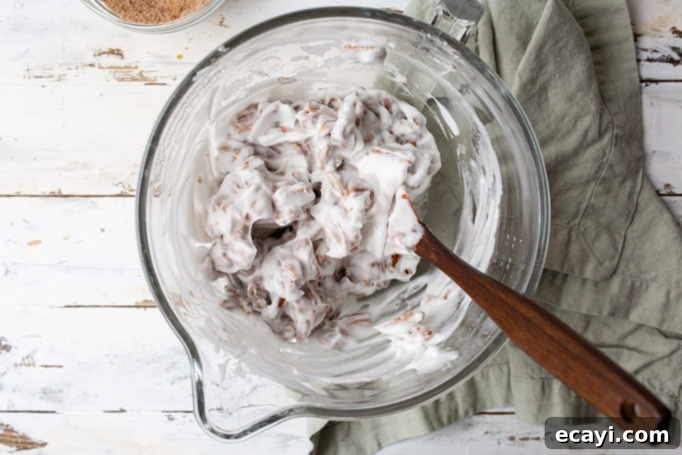 Sweet Pecan Delights 8 Tossing pecan halves in a bowl to coat them evenly with the egg white mixture