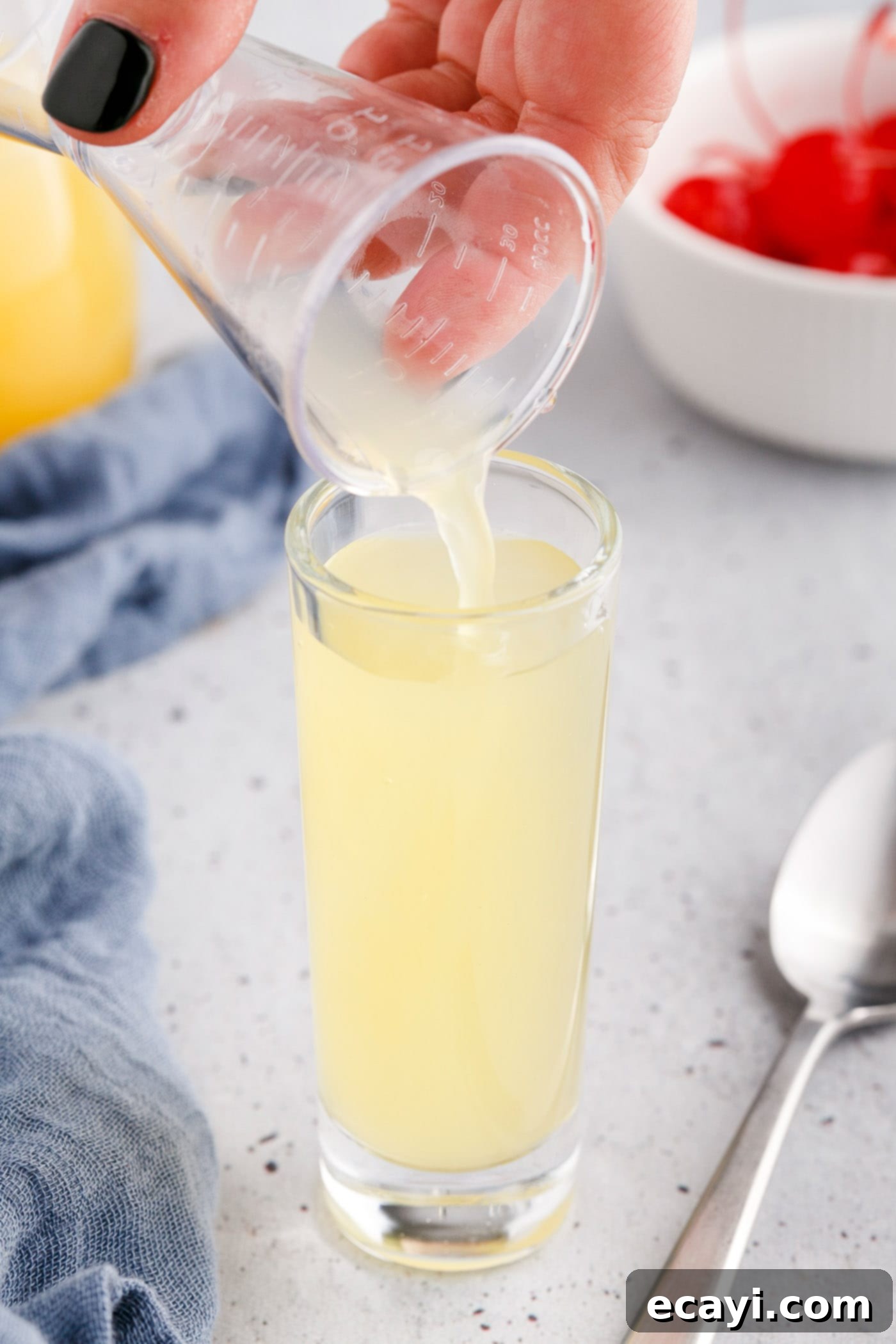 Pineapple Cake Flip Shot 6 pouring pineapple juice to a shot glass