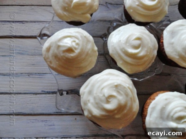 Overhead View of Banana Cupcakes with Vanilla Cream Cheese Frosting Another overhead shot of delectable banana cupcakes, generously adorned with a swirled vanilla cream cheese frosting, creating an inviting visual.
