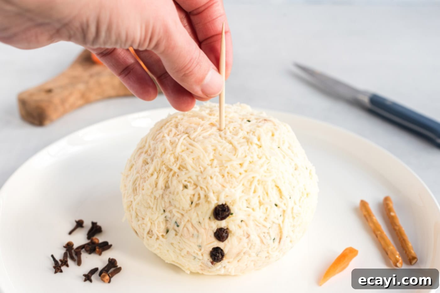 Jolly Snowman Cheeseball 10 toothpick inserted into cheeseball