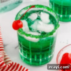 Grinch's Emerald Elixir 8 Grinch Cocktail, a festive green drink for the holidays.
